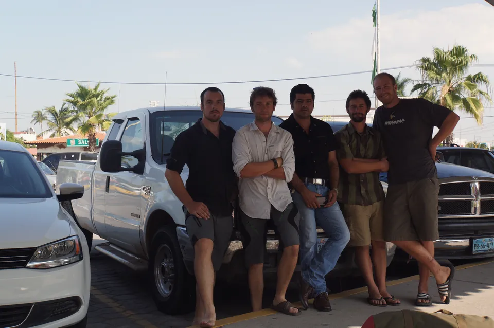 The four riders with a local man leaning on his pickup truck in Nayarit.
